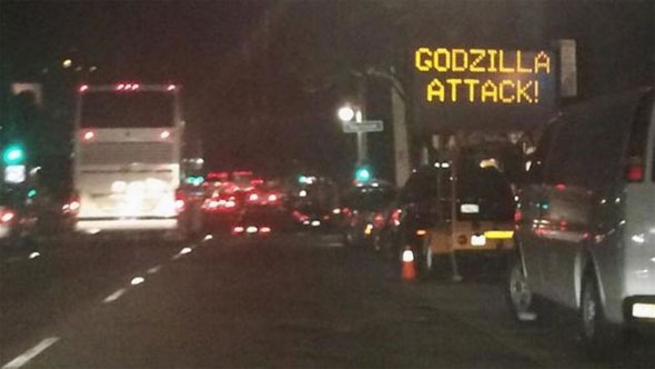 image of hacked road sign which says 'godzilla attack!'